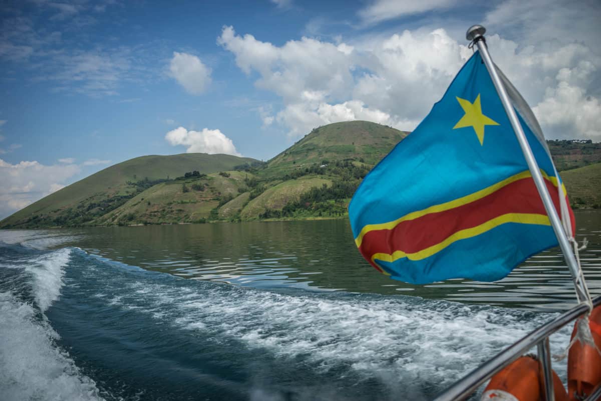 The flag of the Democratic Republic of the Congo flies in the wind on a ferry traveling on Lake Kivu. Photo: Gerry Kahashy